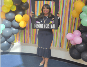 A person holding a life-size photo frame