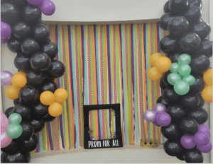 A photo booth with a frame and a colorful background