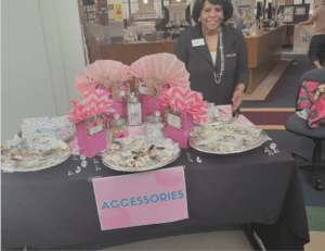 A person sitting near a table with fashion accessories